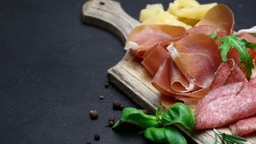 Video of italian meat plate - sliced prosciutto, sausage and cheese
