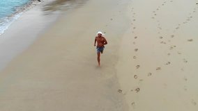 the man is running on the beach