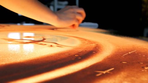 Drawing with sand. Drawing sand on a screen. Sand Artist. Hands draws. Animation