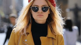 beautiful woman standing on street looking at camera then taking off sunglasses and smiling wind blowing blonde hair female headwear attractive girl fashionable look cute lady sunlight sunny spring - Powered by Shutterstock - Get 15% off with code: PIKWIZARD15