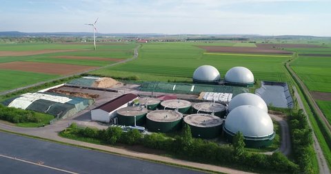 Aerial video of Biogas plant. Flight over Biogas power plants, The agricultural and greenhouse complex is equipped with its own biogas for the production of biogas, Europe,
