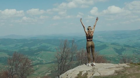 Woman fitness runner on top happy and celebrating success. Female runner on top of the world cheering in winning gesture