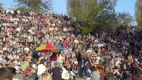 GERMANY - CIRCA APRIL 2017 - People dance sing Karaoke, huge audience crowd, sunny day, Mauer Park, Berlin