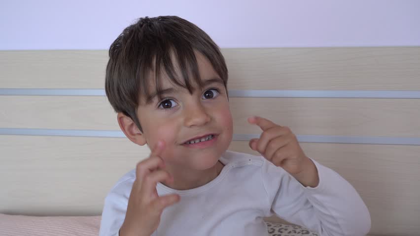 4K Caucasian boy monkeys narrowing his eyes and lolling out
