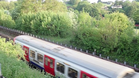 London Underground train passing by in Hertfordshire countryside