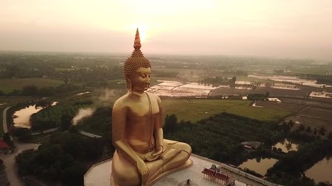 Thailand Wat Ang Thong Golden buddha statue drone footage view sunset 