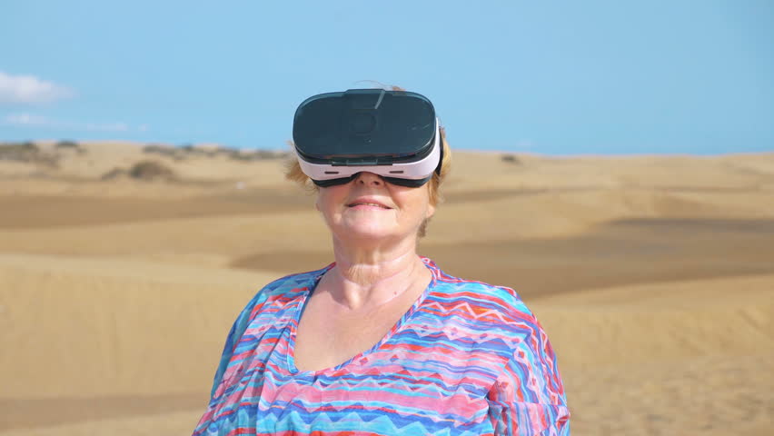 Professional video of senior woman wearing virtual googles on desert in 4k slow motion
 - Powered by Shutterstock - Get 15% off with code: PIKWIZARD15
