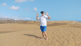 Professional video of senior man  wearing virtual googles on desert in 4k slow motion 