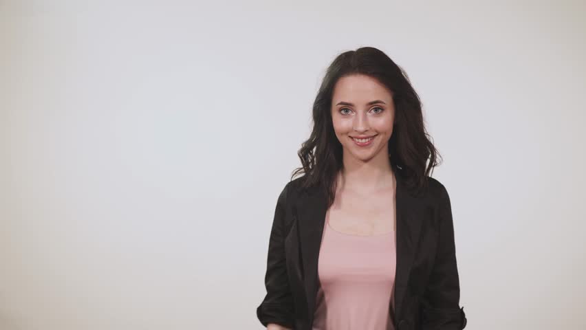 Girl on a white background, showing her hand, space.
