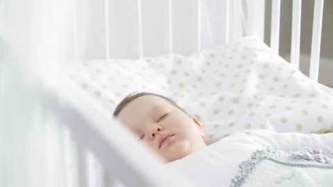 Cute baby girl sleeping in the crib
