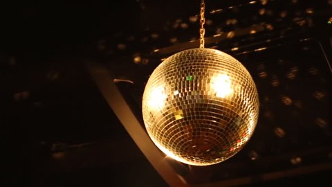 Disco Mirror Ball In the night club close-up. A beautiful mirror ball rotates under the ceiling. Night disco party concept. Show
