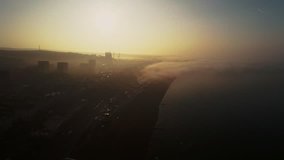 Drone flies backwards through a beautiful misty sunrise to reveal Brighton Pier in Sussex