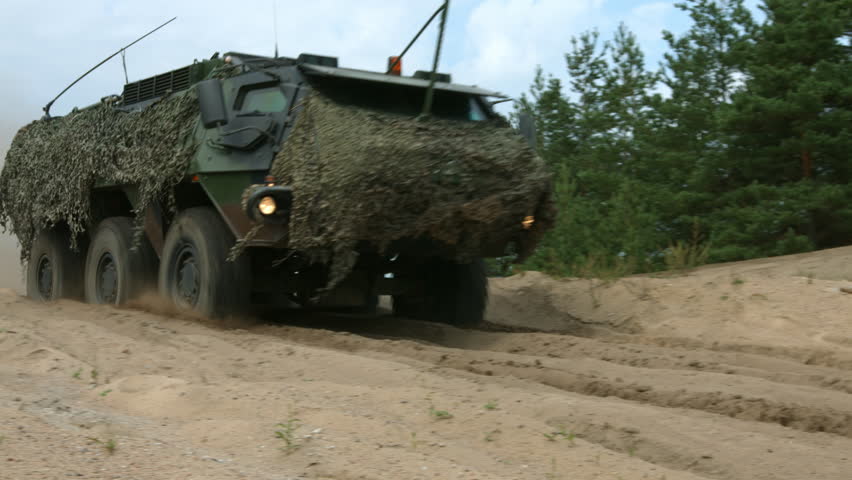 Armored military vehicle 8x8 wheeled BTR driving offroad in sand desert