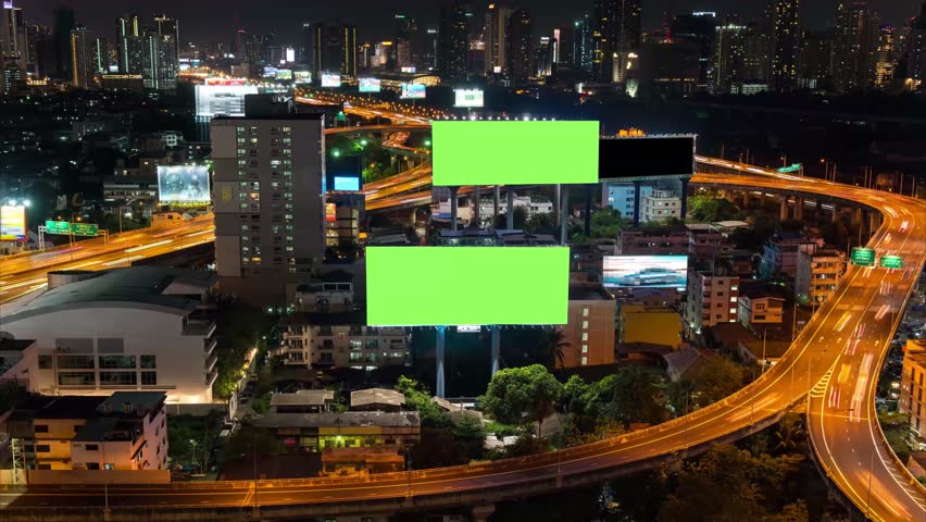 4K Time-lapse: Billboard green screen with city night traffic lights background. Bangkok Thailand. 4K Resolution. Royalty-Free Stock Footage #1010993477