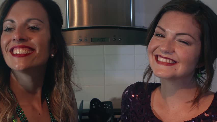 Two women at a party maintain fake smiles while waiting for guests to leave. Royalty-Free Stock Footage #1010994353