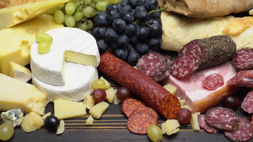 Video of various types of cheese and sausage - parmesan, brie, roquefort