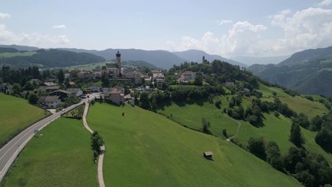 
Völs am Schlern Fié allo Sciliar , Italy - July 24, 2017: Aerial drone video of the city of Völs am Schlern Fié allo Sciliar  on the Italian Alps Dolomites 
