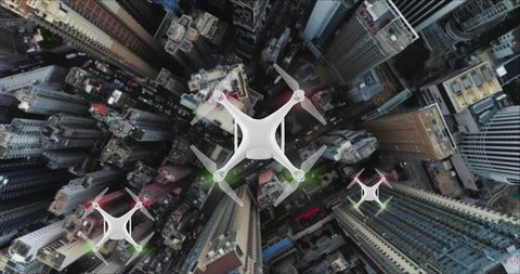 AERIAL. Top view of Group of Drones delivers the goods against the background of Hong Kong city.