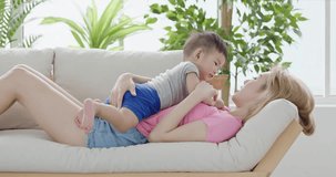 mommy play with son on sofa at home