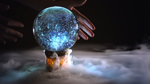4K mysterious hands circling glowing crystal ball box with mist / fog / smoke on black background