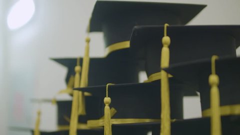 Slow motion detail shot of graduation day caps. Celebrating academic achievement