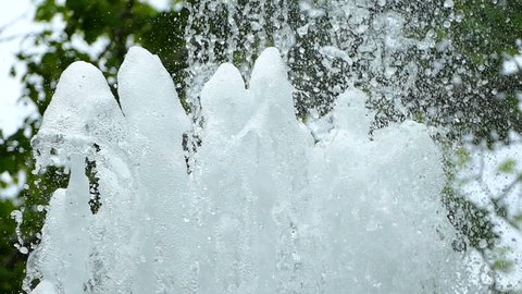 Water stream pouring from fountain in slow motion.