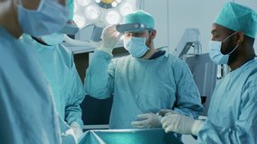 Surgeons Wearing Augmented Reality Glasses Perform State of the Art Mixed Reality Surgery in High Tech Hospital. Doctors and Assistants Working in Operating Room. Shot on RED EPIC-W 8K Helium Camera. - Powered by Shutterstock - Get 15% off with code: PIKWIZARD15