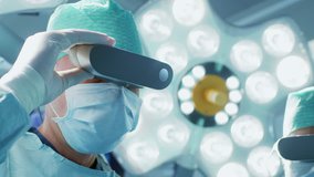Close-up Shot of a Surgeon Putting on Augmented Reality Glasses to Perform State of the Art Surgery in High Tech Hospital. Doctors and Assistants Working in Operating Room. Shot on RED EPIC-W 8K. - Powered by Shutterstock - Get 15% off with code: PIKWIZARD15