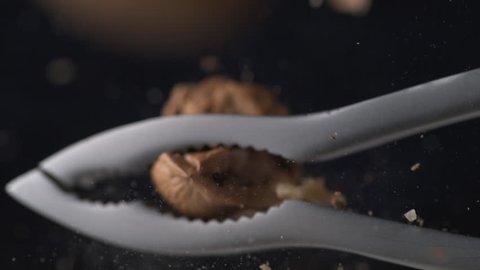Walnut in nut cracker. Shot with high speed camera, phantom flex 4K. Slow Motion.