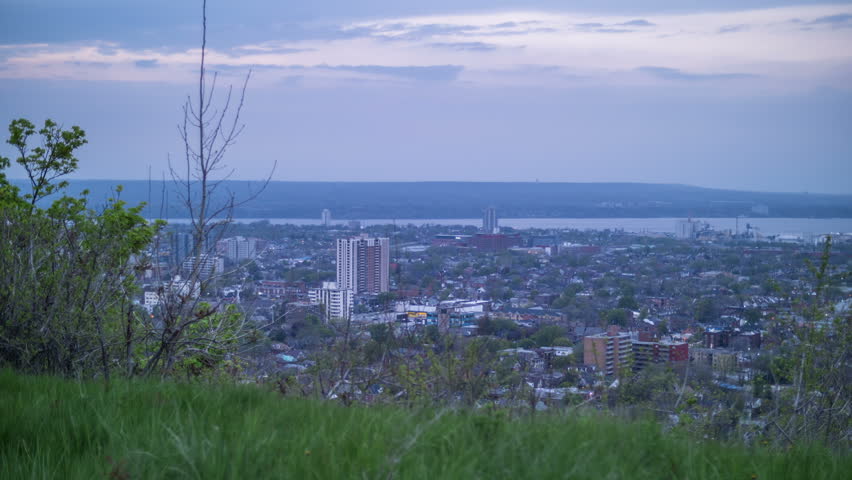 A motion controlled 3 axis day to night time lapse from the escarpment in Hamilton Ontario looking out over the city as the lights begin to turn on.