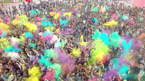 Aerial Flight Above Dancing People Crowd On Holi Festival Of Colors. The festival of colors at the stadium "Open arena" June 12, 2016