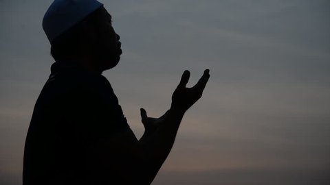 Young asian muslim man praying on sunset,Ramadan festival concept,Thailand people,Blessings from the Allah,