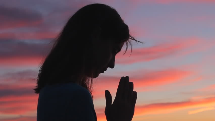 Woman praying looking up with hands open to sky silhouette beautiful sunset Royalty-Free Stock Footage #1011055583