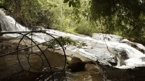 Tropical mountain stream tumbles over rocks as it flows through an exotic. rainforest wilderness area near Chiang Mai. Thailand. Ultra HD 4k video
