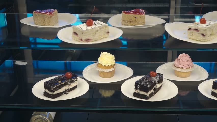Window of a cake shop with a variety of cakes on display. Pies and cakes Dessert store.