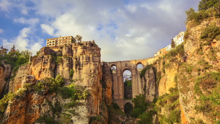 Ronda, Spain- Panning time lapse of Puente Nuevo during sunset golden hour, the iconic bridge in an ancient mountaintop city in souther Spain