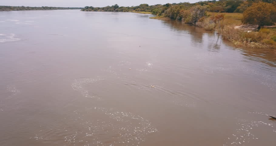 African fisherman in wooden canoe on the Kwanza River. Angola.