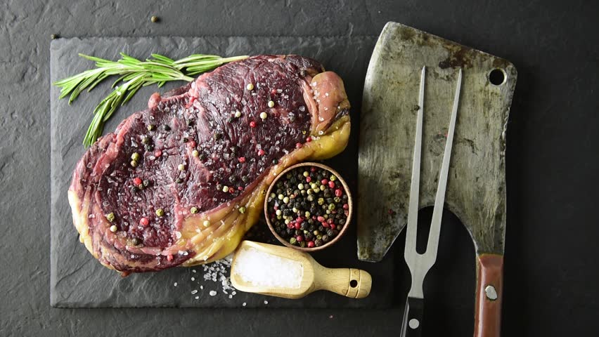 Marbling ribeye steak on black plate. Prime rib beef chop Royalty-Free Stock Footage #1011082706