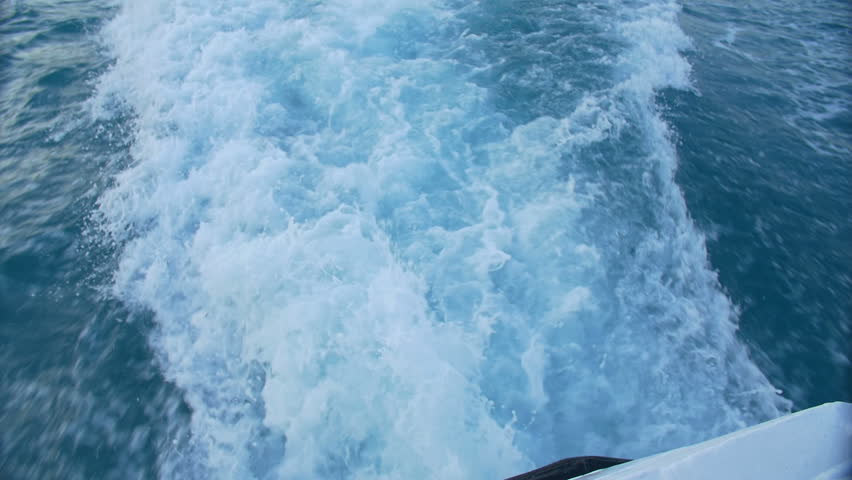 The wake of a boat as seen from the side of a ship. | Shutterstock HD Video #1011084647