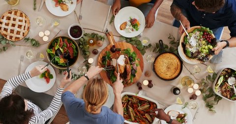 top view of woman carving thanksgiving  turkey young cheerful multi ethnic friends preparing table enjoying vibrant festive season meal together talking bonding over healthy food time lapse rotate