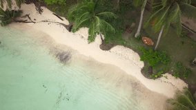 Aerial view of young woman relaxing on hammock in tropical beach paradise, shot in the Philippines on deserted island travel vacations concept. Drone shot, 4K