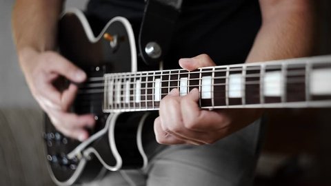Man's hands playing the funky rhythm on electric guitar, electric musical instruments, playing loud on the guitar, rock guitars