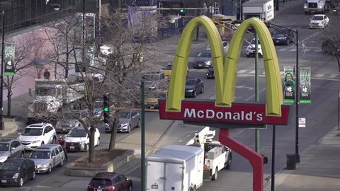 CHICAGO, IL - MARCH 19: Mcdonald's sign along downtown intersection with morning traffic in Chicago, Illinois on March 19, 2018.