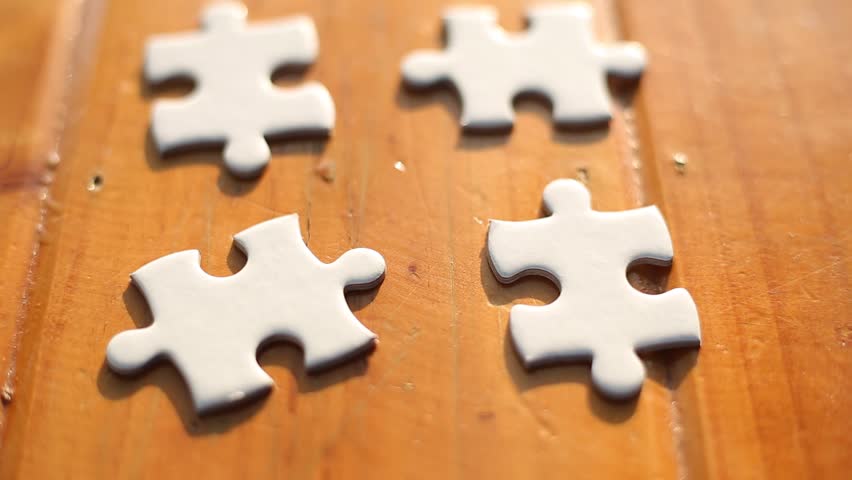 Hand holding jigsaw puzzles,Business group wanting to put pieces of puzzle together.