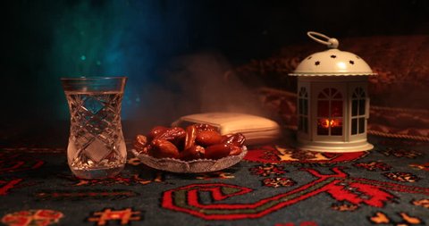 Water and dates. Iftar is the evening meal. Slider view of decoration Ramadan Kareem holiday. Festive greeting card, invitation for Muslim holy month Ramadan Kareem. Dark background. Selective focus
