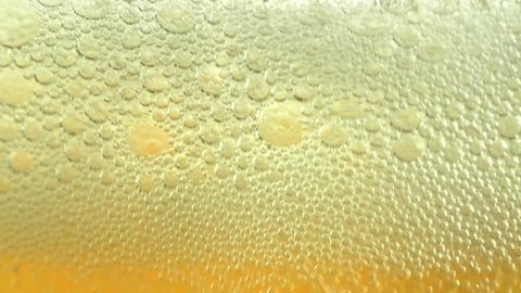 Close up of carbonated drink beer being poured in a glass