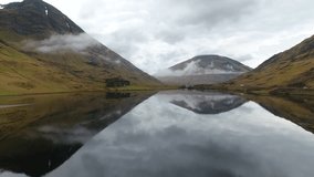 4K Aerial shot of Glencoe Loch Achtiochtan Lake in Scottish highlands. Scotland mountain landscape. British countryside and hills. 
