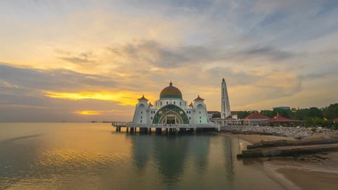 Dramatic Time lapse of sunset and scattered clouds at a mosque in Melaka, Malaysia. 4K resolution, 3840 x 2160. Day to Night.