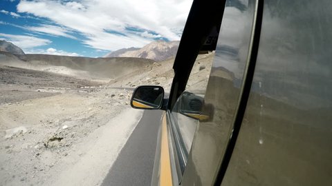 Leh - Nubra Valley road in Nothern India, Ladakh region. SUV car goes by the serpentine road.