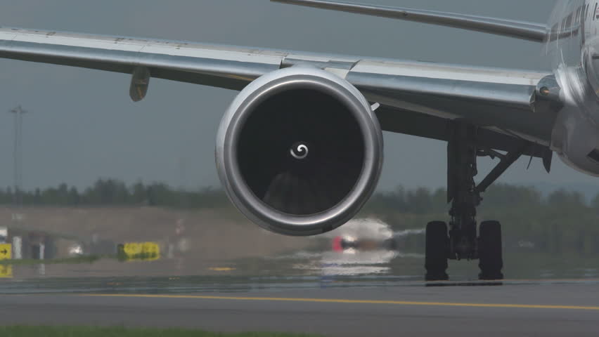 huge airplane jet engine close up view moving forward heat haze distant airplane lining up behind Royalty-Free Stock Footage #1011152111